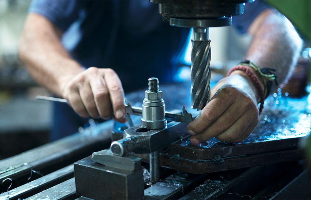 Close-up of a technician measuring a machined part